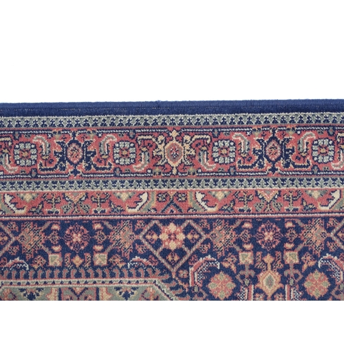 1372 - Carpet / Rug : A blue ground runner decorated with three central medallions with floral and scroll d... 