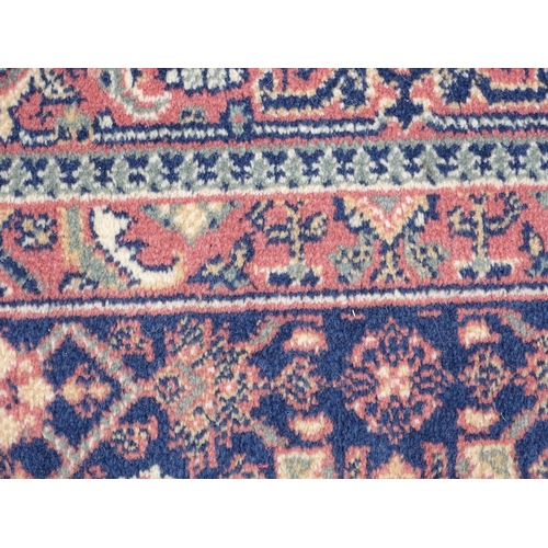 1372 - Carpet / Rug : A blue ground runner decorated with three central medallions with floral and scroll d... 