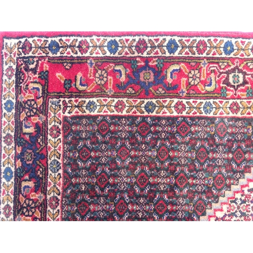 1396 - Carpet / Rug: A North West Persian Senneh rug, the red, blue and cream grounds decorated with repeat... 