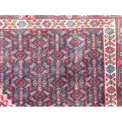 1396 - Carpet / Rug: A North West Persian Senneh rug, the red, blue and cream grounds decorated with repeat... 