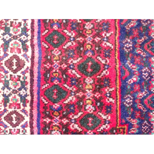 1396 - Carpet / Rug: A North West Persian Senneh rug, the red, blue and cream grounds decorated with repeat... 