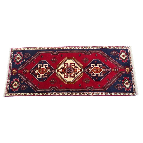 1397 - Carpet / Rug: A South West Persian qashgai runner, the red and blue ground with central geometric mo... 