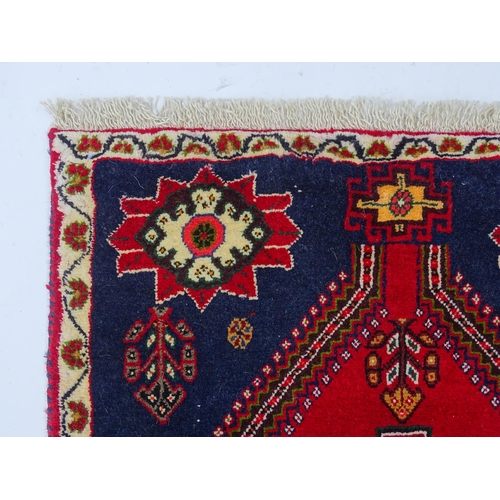 1397 - Carpet / Rug: A South West Persian qashgai runner, the red and blue ground with central geometric mo... 