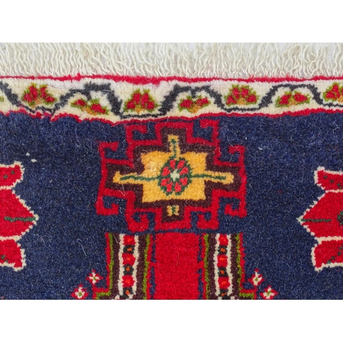 1397 - Carpet / Rug: A South West Persian qashgai runner, the red and blue ground with central geometric mo... 