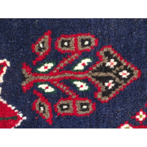 1397 - Carpet / Rug: A South West Persian qashgai runner, the red and blue ground with central geometric mo... 