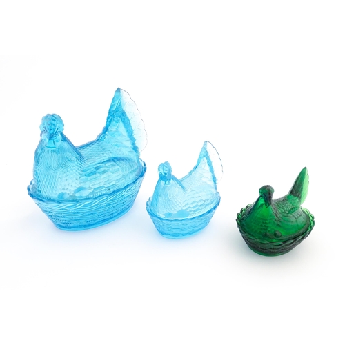 1155 - Three 20thC glass hen on nest egg containers, comprising two blue and one green. Largest approx. 8 1... 