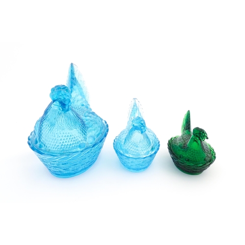 1155 - Three 20thC glass hen on nest egg containers, comprising two blue and one green. Largest approx. 8 1... 