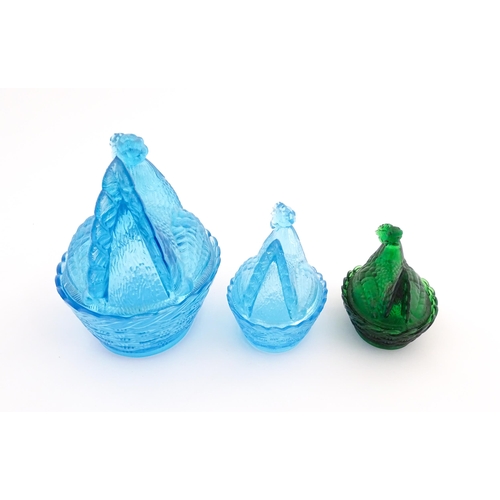 1155 - Three 20thC glass hen on nest egg containers, comprising two blue and one green. Largest approx. 8 1... 