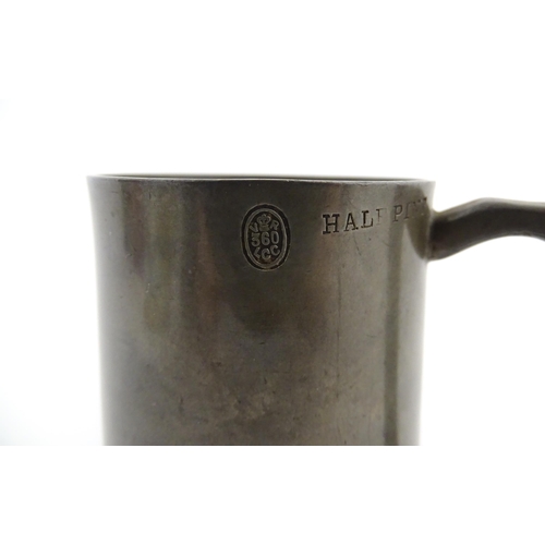 1156 - A Victorian pewter half pint tankard mug stamped W. R. Loftus, with a glass base, the body engraved ... 