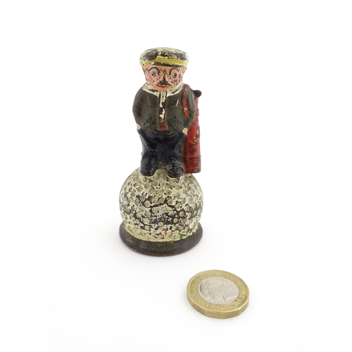 1160 - A 20thC Dunlop advertising table bell modelled as a golfer standing upon a golf ball, with polychrom... 