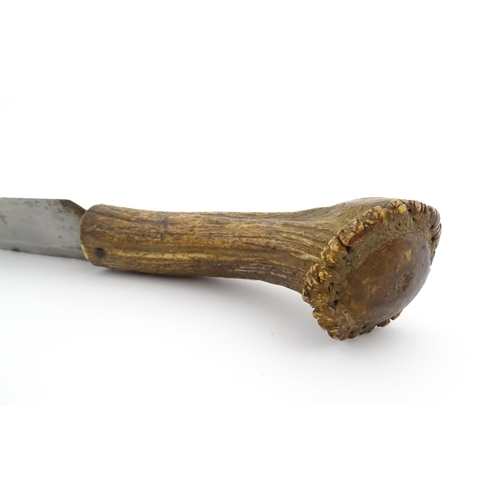 1171 - Kitchenalia : an early 20thC butcher's slicing knife, with antler handle, steel blade and wooden she... 