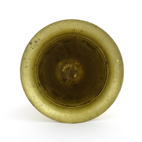 1174 - A 19thC brass pestle and mortar, the mortar of tapering form with twin rectangular handles. Mortar a... 