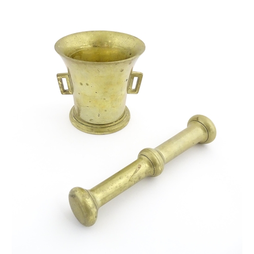 1174 - A 19thC brass pestle and mortar, the mortar of tapering form with twin rectangular handles. Mortar a... 