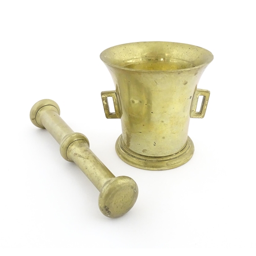 1174 - A 19thC brass pestle and mortar, the mortar of tapering form with twin rectangular handles. Mortar a... 