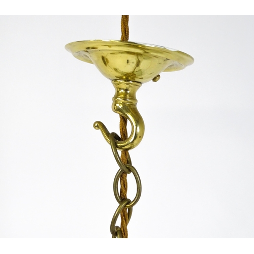 1403 - A pair of brass pendant lights having three scrolling branches with three holophane shades. Approx. ... 