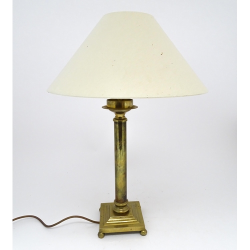 1417 - A brass table lamp of column form on squared base. Approx. 18