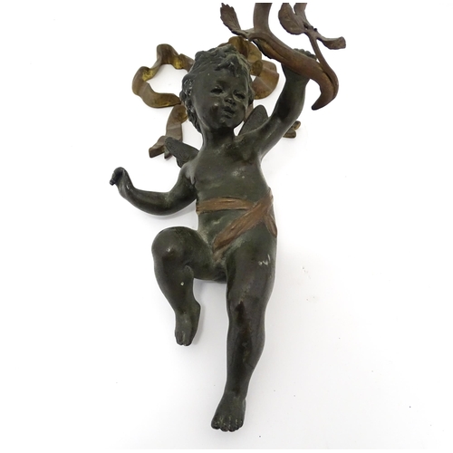 1421 - A cast bronze wall light sconce modelled as a cherub holding aloft a scrolling flower. Approx. 12