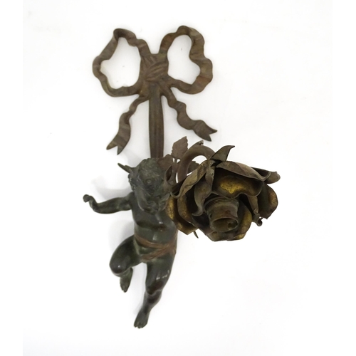 1421 - A cast bronze wall light sconce modelled as a cherub holding aloft a scrolling flower. Approx. 12