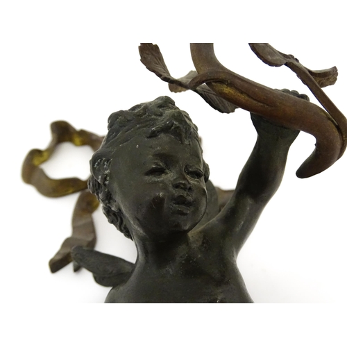 1421 - A cast bronze wall light sconce modelled as a cherub holding aloft a scrolling flower. Approx. 12