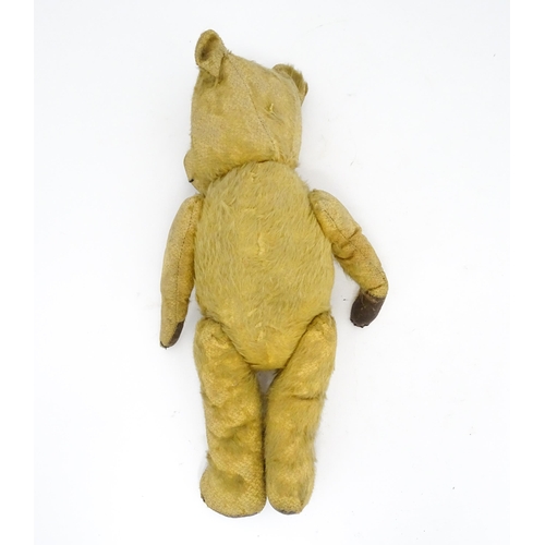 941 - Toy: An early 20thC mohair straw filled teddy bear with stitched nose and mouth, articulated limbs a... 