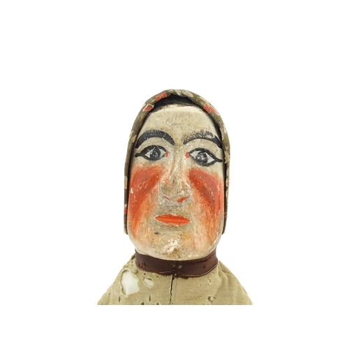 942 - Toy: A 19thC French glove puppet with wooden head and hands and hand painted features. Approx. 18