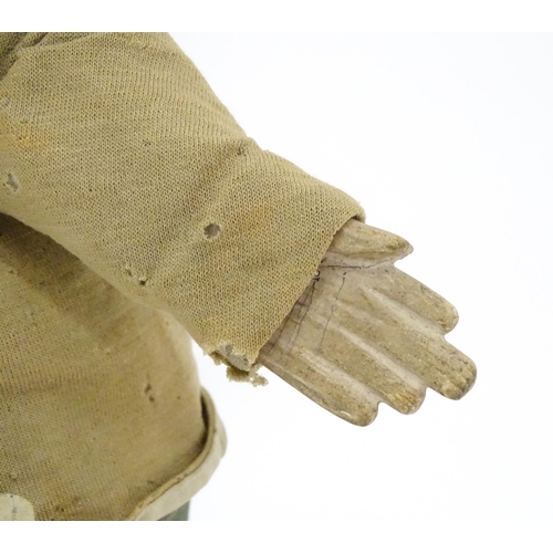 942 - Toy: A 19thC French glove puppet with wooden head and hands and hand painted features. Approx. 18