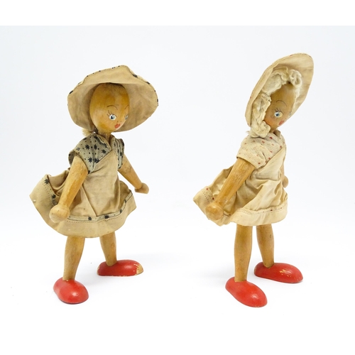 949 - Toys: Two vintage Continental wooden peg dolls with painted features. Approx. 7 1/4