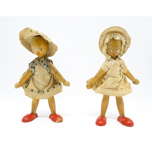 949 - Toys: Two vintage Continental wooden peg dolls with painted features. Approx. 7 1/4