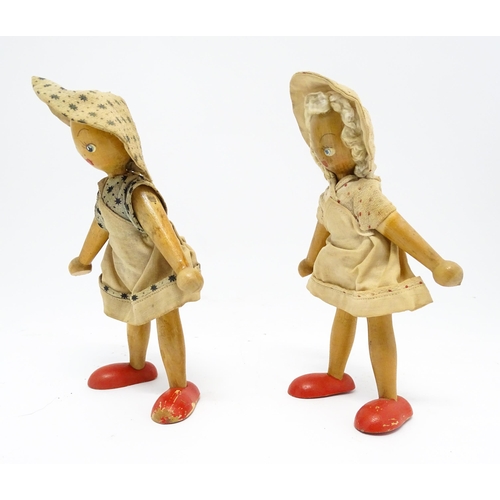 949 - Toys: Two vintage Continental wooden peg dolls with painted features. Approx. 7 1/4