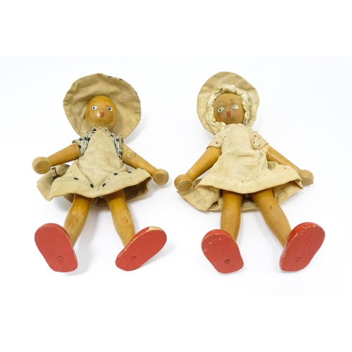 949 - Toys: Two vintage Continental wooden peg dolls with painted features. Approx. 7 1/4