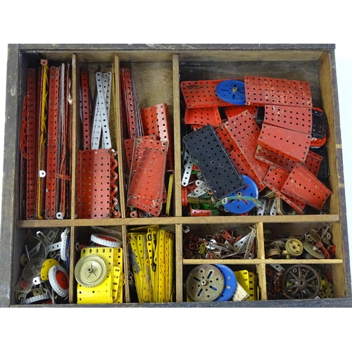 962 - Toys: A quantity of assorted Meccano parts to include flat plates, girders, wheels, and tools