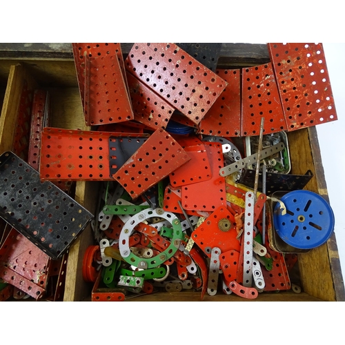 962 - Toys: A quantity of assorted Meccano parts to include flat plates, girders, wheels, and tools