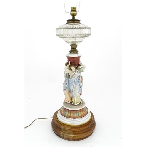 1411 - A table lamp formed from an oil lamp with ceramic figural base. Approx. 22