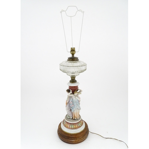 1411 - A table lamp formed from an oil lamp with ceramic figural base. Approx. 22