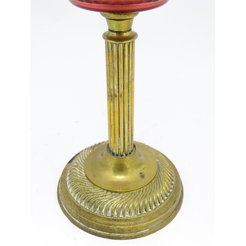 1412 - A late 19th / early 20thC oil lamp with brass column and cranberry glass reservoir with etched glass... 