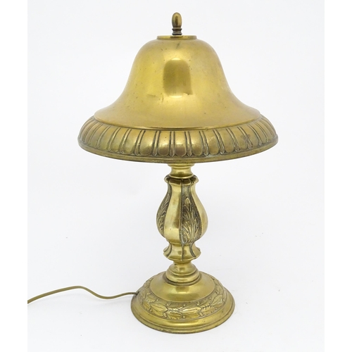 1422 - A 20thC brass table lamp with foliate detail and brass domed shade. Approx. 17