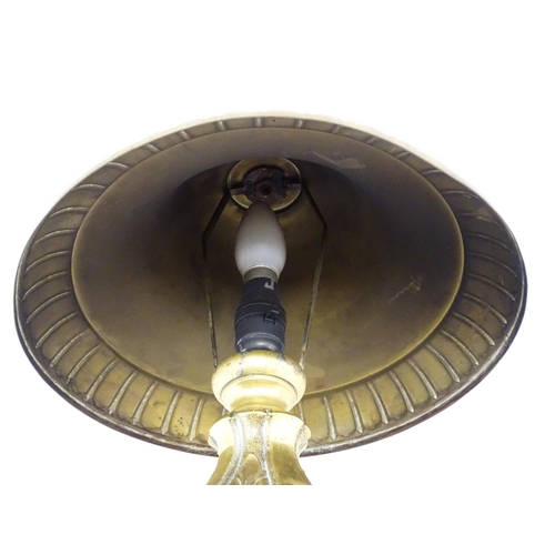 1422 - A 20thC brass table lamp with foliate detail and brass domed shade. Approx. 17