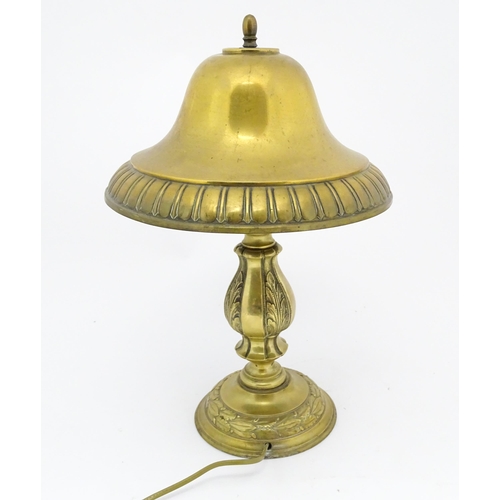 1422 - A 20thC brass table lamp with foliate detail and brass domed shade. Approx. 17