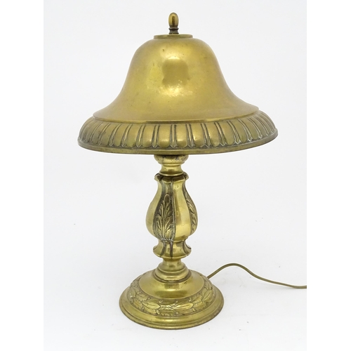 1422 - A 20thC brass table lamp with foliate detail and brass domed shade. Approx. 17