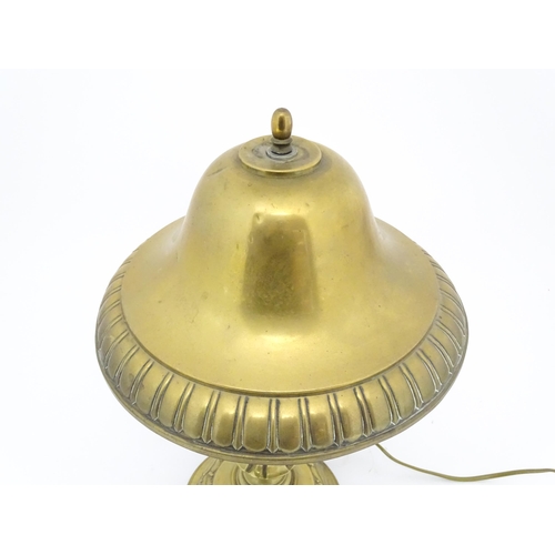 1422 - A 20thC brass table lamp with foliate detail and brass domed shade. Approx. 17