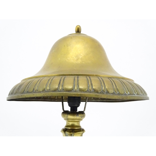 1422 - A 20thC brass table lamp with foliate detail and brass domed shade. Approx. 17