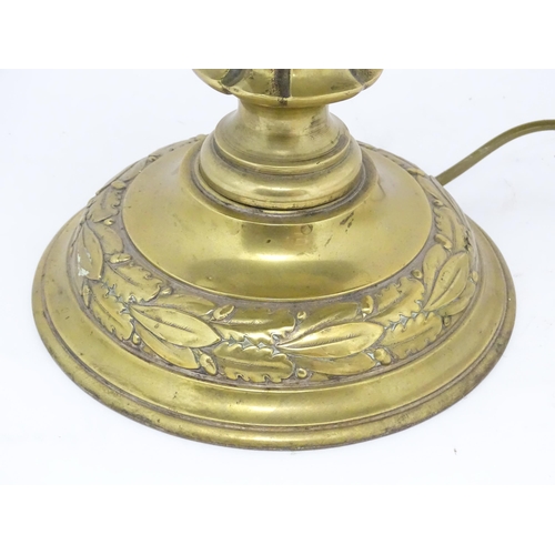 1422 - A 20thC brass table lamp with foliate detail and brass domed shade. Approx. 17