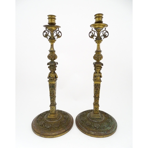 1423 - A pair of 19thC Continental cast brass tall candlesticks with figural, lions mask and foliate detail... 