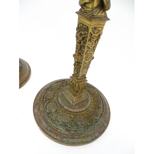 1423 - A pair of 19thC Continental cast brass tall candlesticks with figural, lions mask and foliate detail... 