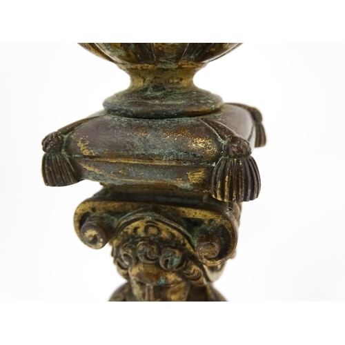 1423 - A pair of 19thC Continental cast brass tall candlesticks with figural, lions mask and foliate detail... 