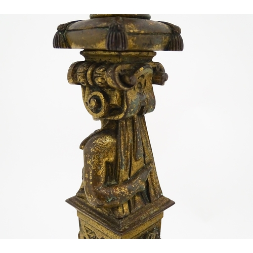 1423 - A pair of 19thC Continental cast brass tall candlesticks with figural, lions mask and foliate detail... 