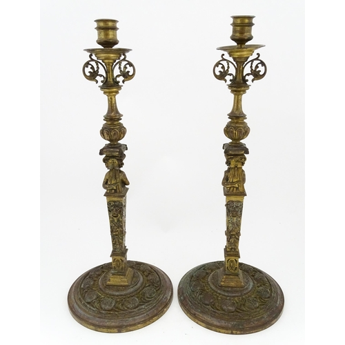 1423 - A pair of 19thC Continental cast brass tall candlesticks with figural, lions mask and foliate detail... 