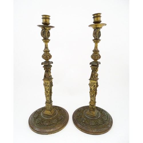 1423 - A pair of 19thC Continental cast brass tall candlesticks with figural, lions mask and foliate detail... 