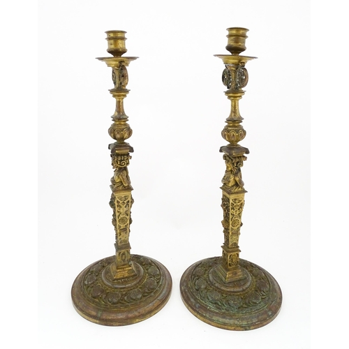 1423 - A pair of 19thC Continental cast brass tall candlesticks with figural, lions mask and foliate detail... 