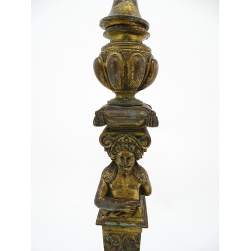 1423 - A pair of 19thC Continental cast brass tall candlesticks with figural, lions mask and foliate detail... 